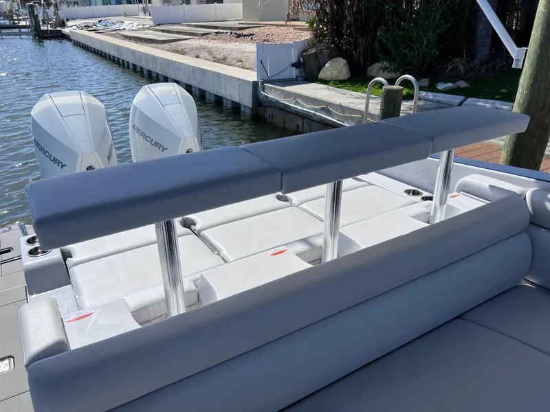 Slide: The Image of 2022 Aviara AV 32 Outboard boat with dual Mercury engines, docked by a canal. - 32