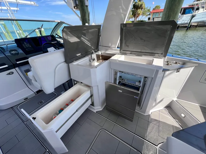 Slide: The Image of Aviara AV 32 Outboard 2022 boat interior with open storage and seating area. - 36
