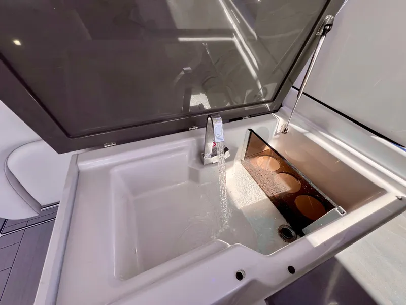 Slide: The Image of Aviara AV 32 Outboard 2022 boat sink with running water and cover. - 37