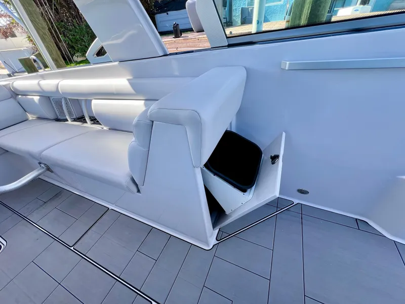 Slide: The Image of 2022 Aviara AV 32 Outboard interior with white seating and storage compartment. - 43