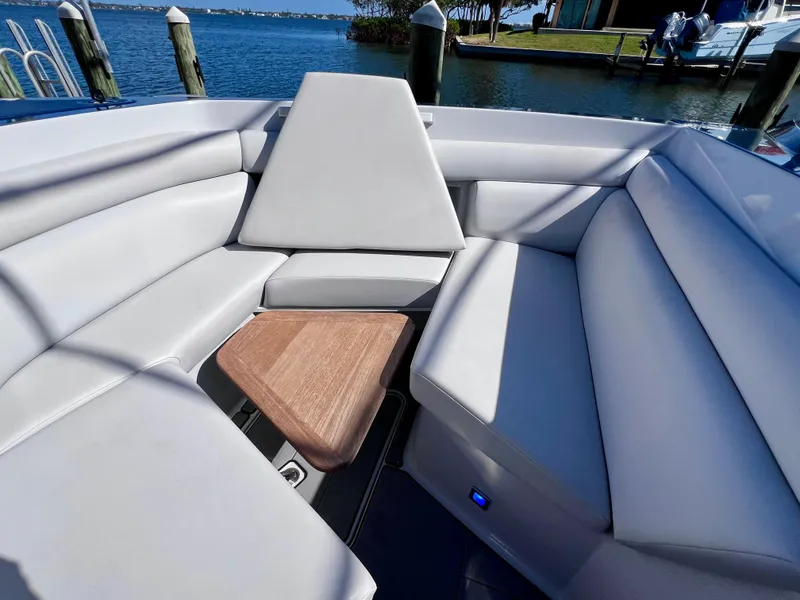 Slide: The Image of 2022 Aviara AV 32 Outboard boat interior with luxurious seating and wooden accents. - 48