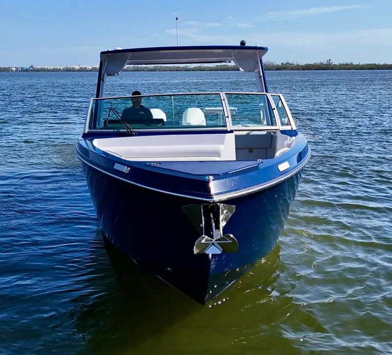 Slide: The Image of 2022 Aviara AV 32 Outboard boat on calm water, front view. - 7