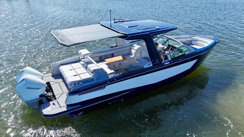 Slide: The Image of 2022 Aviara AV 32 Outboard boat on water, featuring spacious seating and modern design. - 9