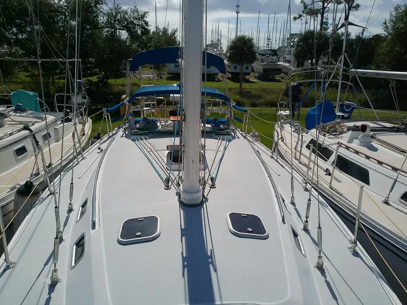Slide: The Image of 1995 Catalina 36 MkII sailboat deck view with marina background. - 14