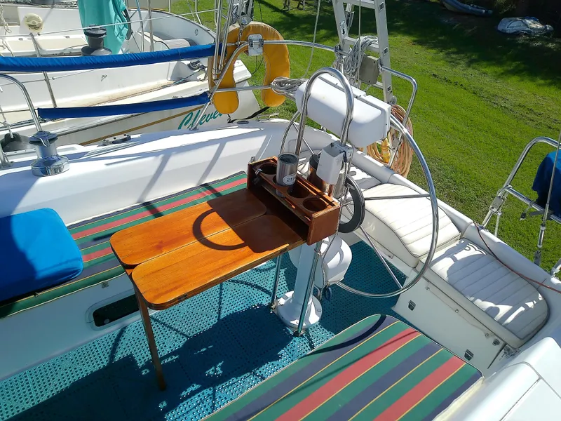 Slide: The Image of Catalina 36 MkII 1995 sailboat cockpit with wooden table and striped seating. - 18