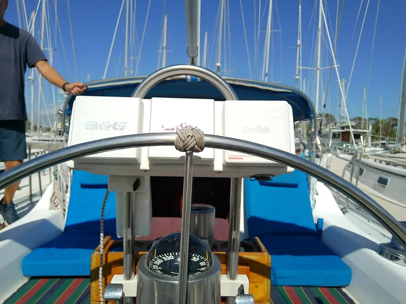 Slide: The Image of Cockpit view of 1995 Catalina 36 MkII sailboat with steering wheel and navigation equipment. - 19