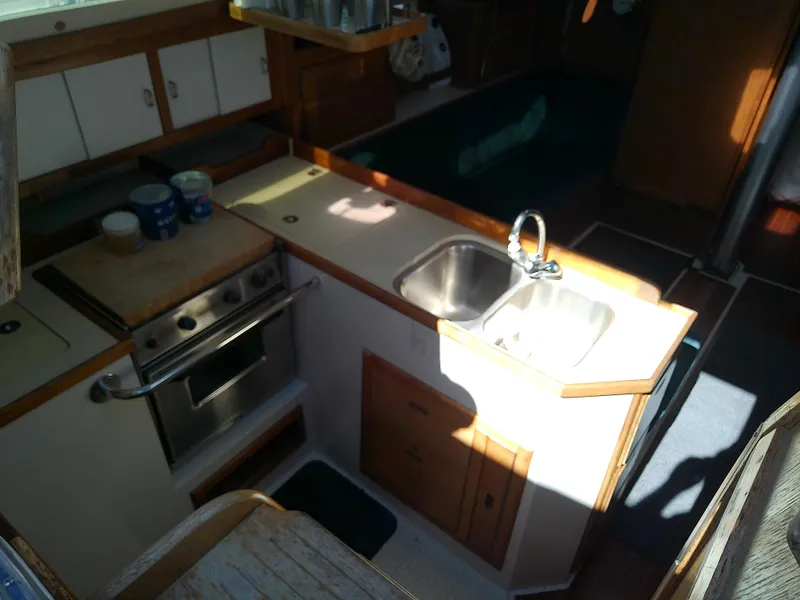 Slide: The Image of 1995 Catalina 36 MkII yacht kitchen interior with sink, stove, and storage cabinets. - 28