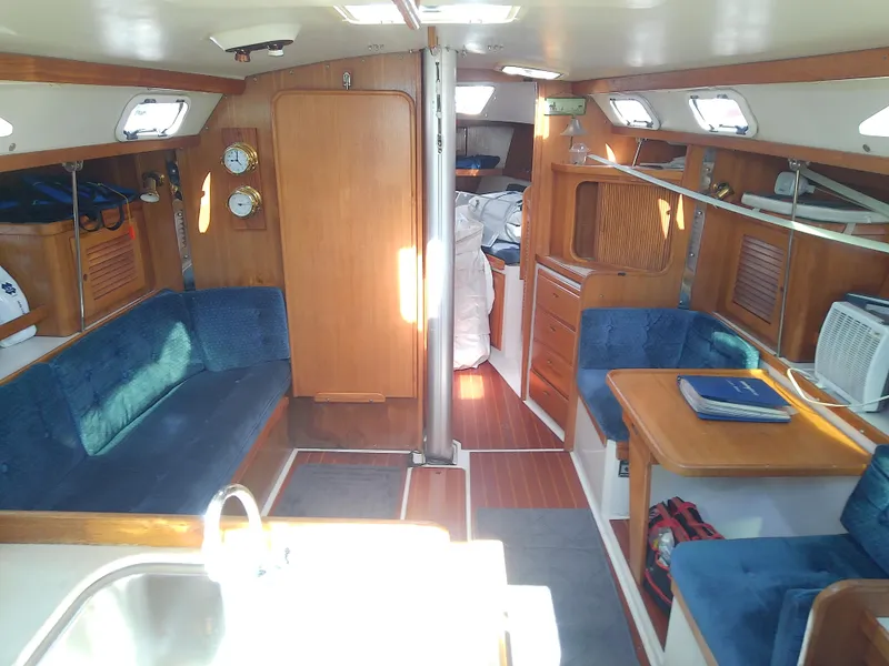 Slide: The Image of Interior of a 1995 Catalina 36 MkII sailboat with blue seating and wooden finishes. - 29