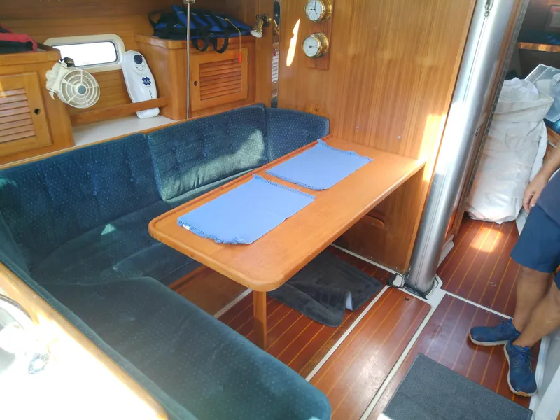 Slide: The Image of Interior of 1995 Catalina 36 MkII sailboat with wooden table and blue cushioned seating. - 31