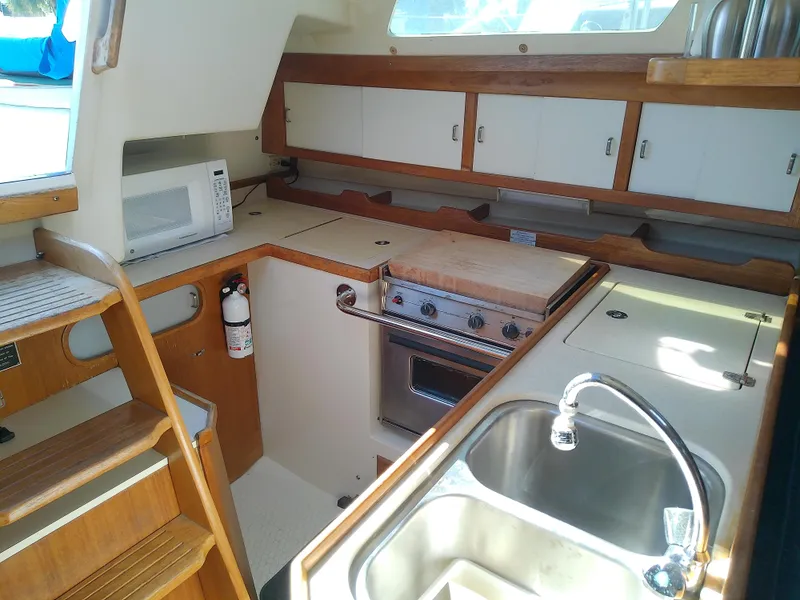 Slide: The Image of Catalina 36 MkII 1995 yacht kitchen with stove, sink, and microwave. - 37