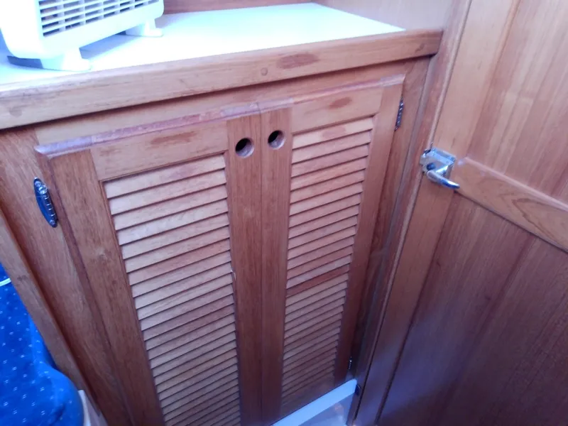 Slide: The Image of Wooden cabinet doors inside a 1995 Catalina 36 MkII sailboat interior. - 38