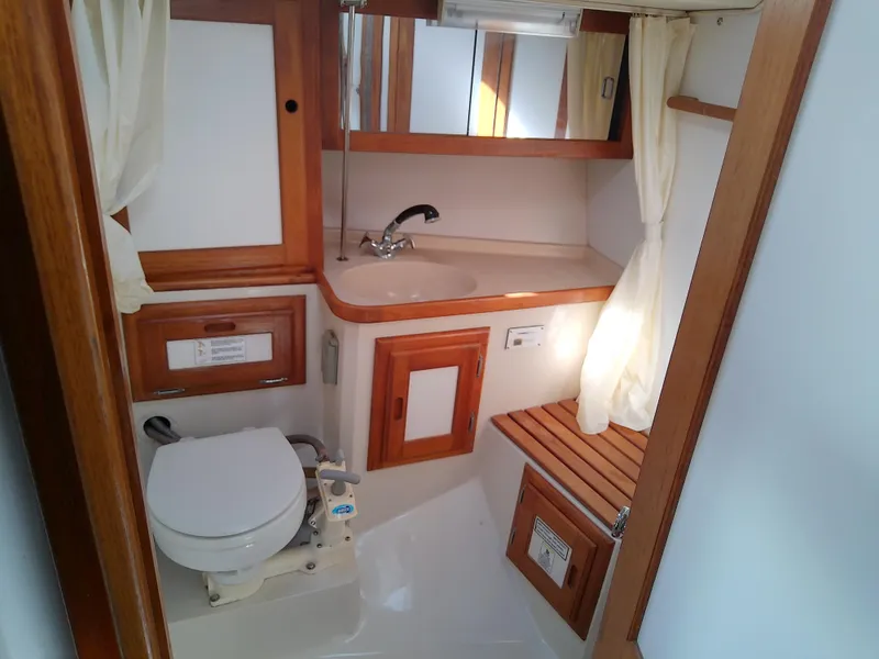 Slide: The Image of 1995 Catalina 36 MkII yacht bathroom with wooden accents and compact design. - 44