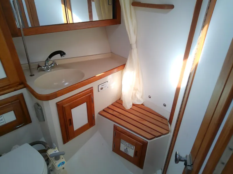 Slide: The Image of 1995 Catalina 36 MkII bathroom with wooden accents and compact design. - 45