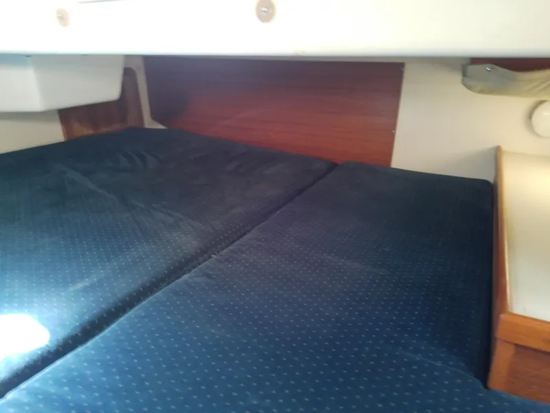 Slide: The Image of Interior cabin of 1995 Catalina 36 MkII sailboat with blue cushioned seating. - 48