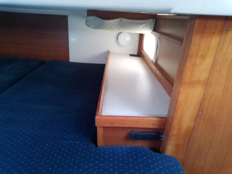 Slide: The Image of Interior cabin of 1995 Catalina 36 MkII sailboat with wooden storage and blue bedding. - 49