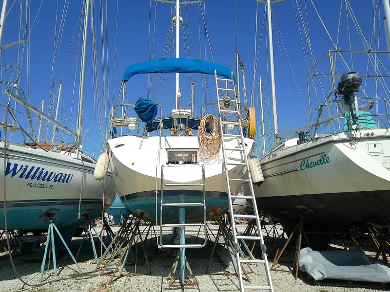 Slide: The Image of 1995 Catalina 36 MkII sailboat on stands, surrounded by other boats, clear blue sky. - 6