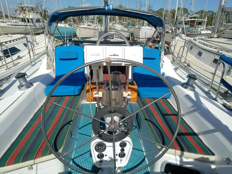 Slide: The Image of 1995 Catalina 36 MkII sailboat cockpit with striped cushions and steering wheel. - 7