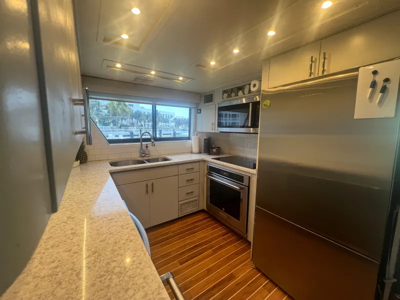 Slide: The Image of Modern kitchen interior of 1990 Hatteras 70 Cockpit Motor Yacht with stainless steel appliances. - 22