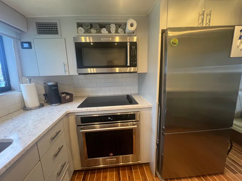 Slide: The Image of Modern kitchen in 1990 Hatteras 70 Cockpit Motor Yacht with stainless steel appliances. - 23