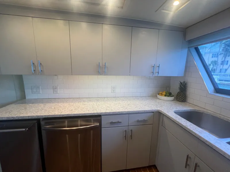 Slide: The Image of Modern kitchen in 1990 Hatteras 70 Cockpit Motor Yacht with sleek cabinets and stainless steel appliances. - 25