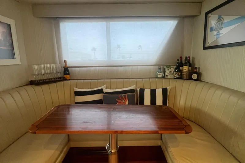 Slide: The Image of Luxurious dining area in 1990 Hatteras 70 Cockpit Motor Yacht with elegant decor. - 29