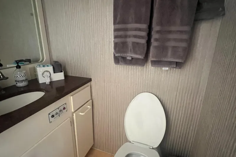 Slide: The Image of Bathroom interior of 1990 Hatteras 70 Cockpit Motor Yacht with towels and sink. - 34