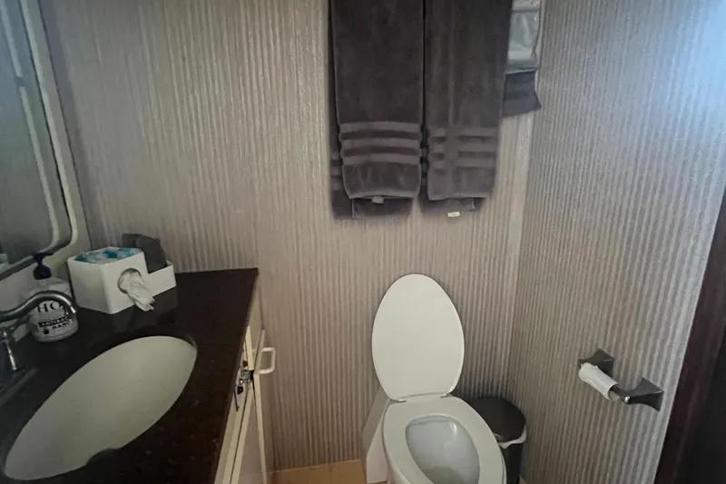 Slide: The Image of Bathroom interior of 1990 Hatteras 70 Cockpit Motor Yacht with modern amenities. - 35