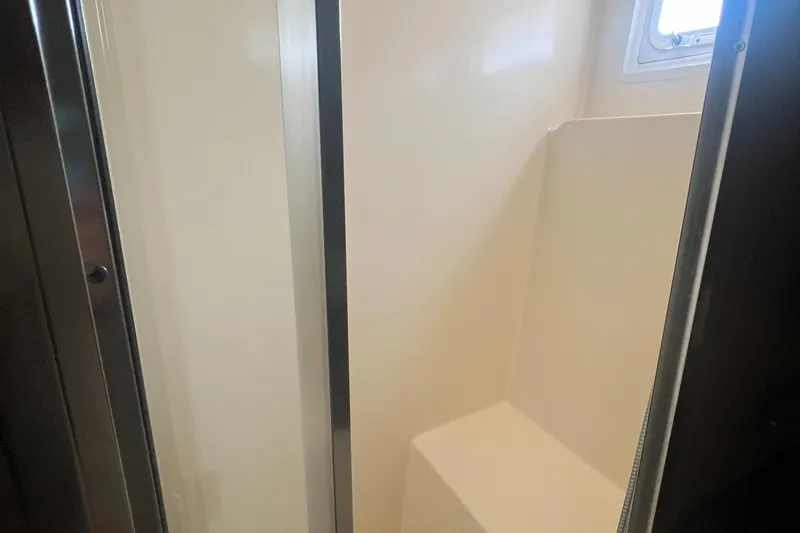 Slide: The Image of Shower area in 1990 Hatteras 70 Cockpit Motor Yacht, featuring sleek design and compact space. - 38