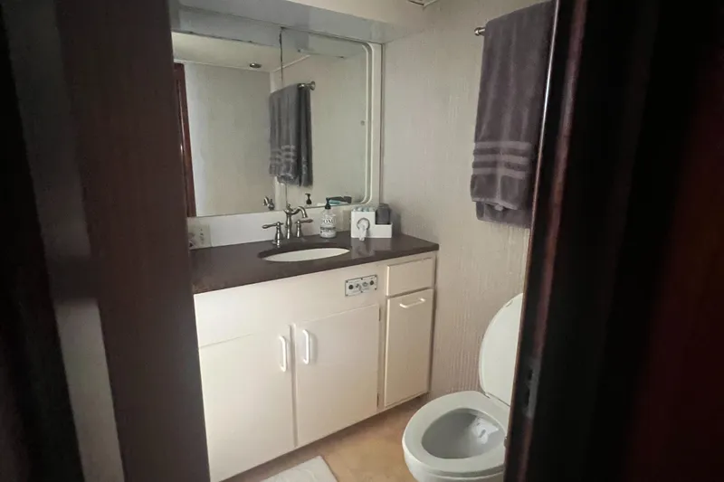 Slide: The Image of Bathroom interior of 1990 Hatteras 70 Cockpit Motor Yacht with sink and toilet. - 39