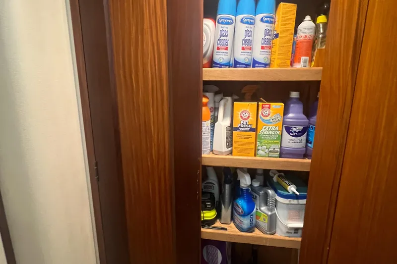 Slide: The Image of Storage cabinet with cleaning supplies on a 1990 Hatteras 70 Cockpit Motor Yacht. - 43