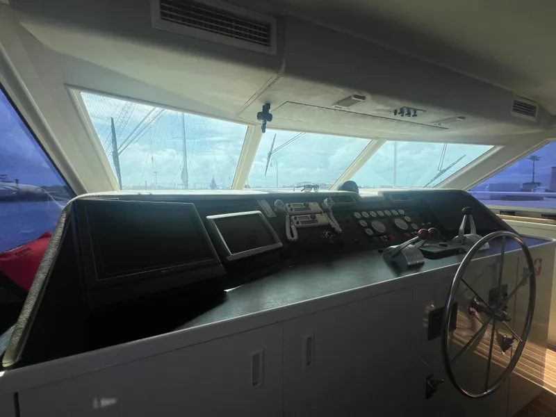 Slide: The Image of Interior helm of 1990 Hatteras 70 Cockpit Motor Yacht with steering wheel and navigation equipment. - 47
