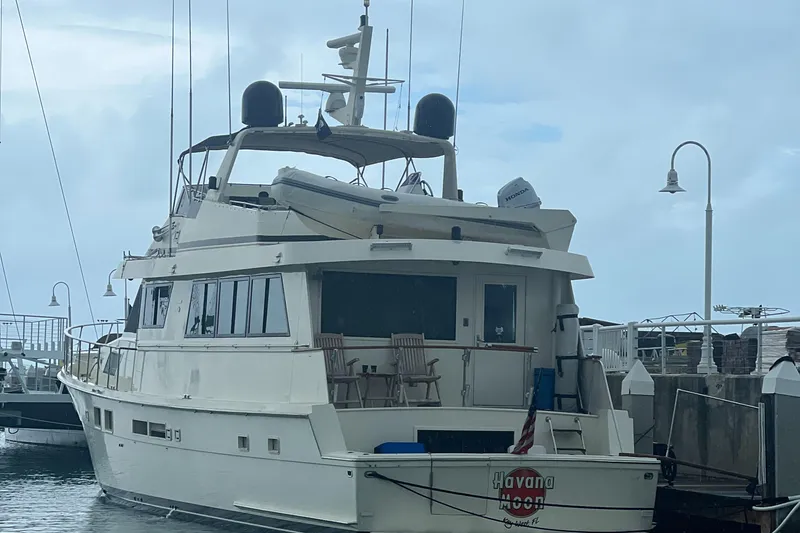 Slide: The Image of 1990 Hatteras 70 Cockpit Motor Yacht docked at marina. - 8