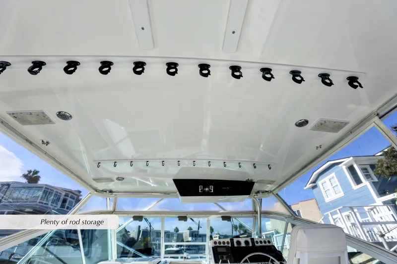 Slide: The Image of 2000 Cabo 35 Express boat interior with ample rod storage on the ceiling. - 11