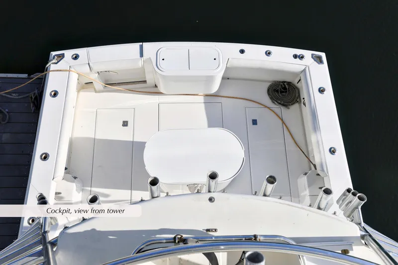 Slide: The Image of Cockpit view of 2000 Cabo 35 Express boat, featuring fishing rod holders and storage. - 16