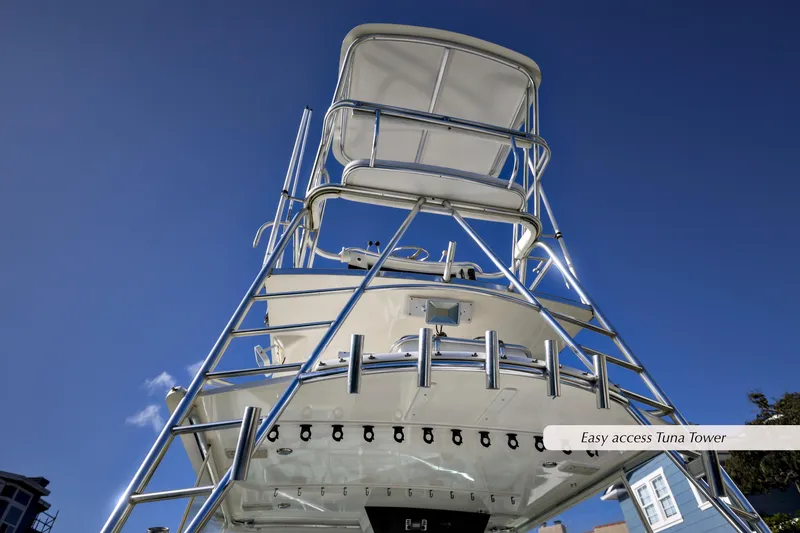 Slide: The Image of Cabo 35 Express 2000 boat with tuna tower against clear blue sky. - 18