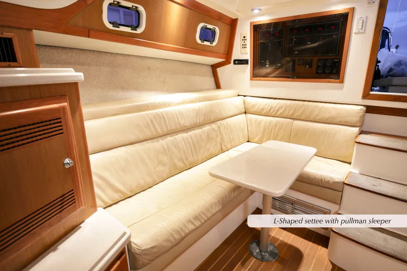 Slide: The Image of L-shaped settee with pullman sleeper in 2000 Cabo 35 Express yacht interior. - 22