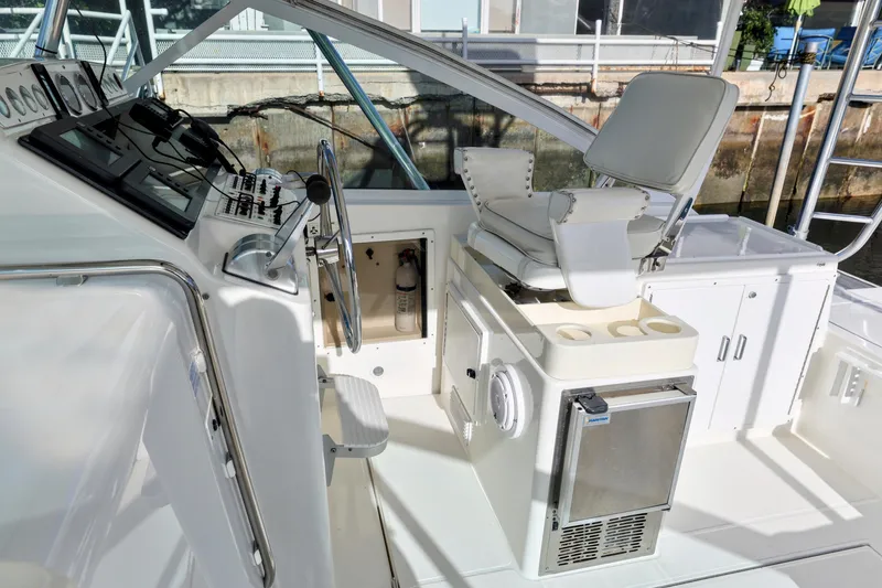 Slide: The Image of Cockpit of 2000 Cabo 35 Express boat with helm, seating, and control panel. - 3