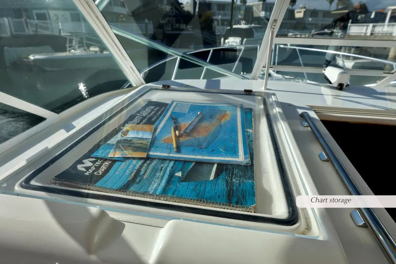 Slide: The Image of Chart storage on 2000 Cabo 35 Express boat, featuring navigational maps. - 5