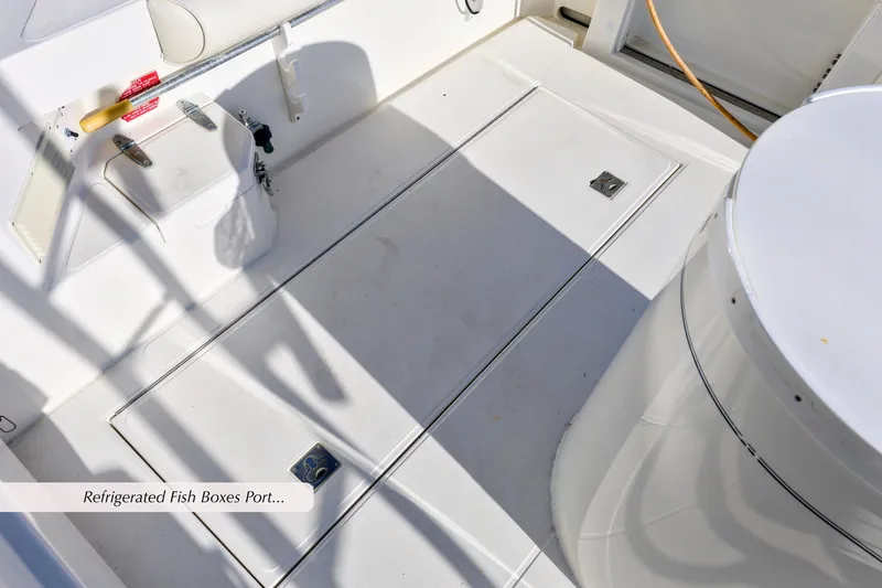 Slide: The Image of Cabo 35 Express 2000 boat deck with refrigerated fish boxes and storage compartments. - 9