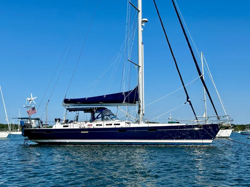 Slide: The Image of Sailing yacht Beneteau 57, 2010 model, anchored on calm water under clear blue sky. - 1