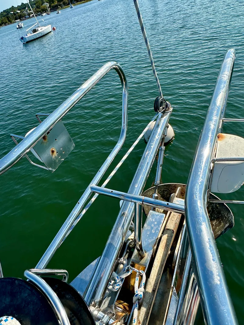 Slide: The Image of Bow of 2010 Beneteau 57 sailboat with stainless steel railings on calm water. - 11