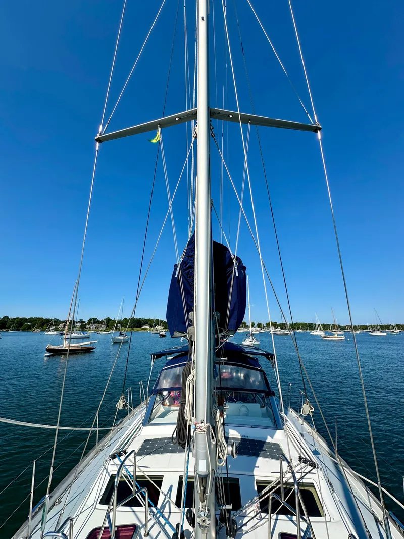 Slide: The Image of Sailing yacht Beneteau 57, 2010 model, on calm waters under clear blue sky. - 16