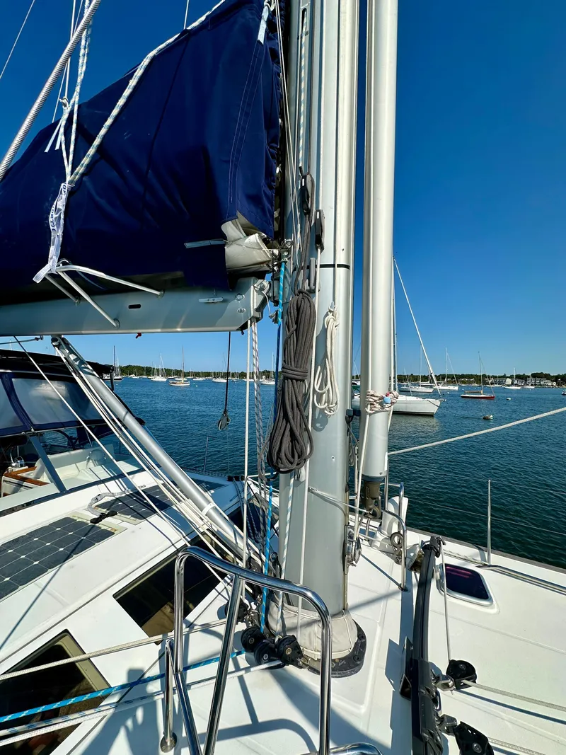Slide: The Image of Sailboat deck view of 2010 Beneteau 57 with clear blue sky and calm waters. - 17