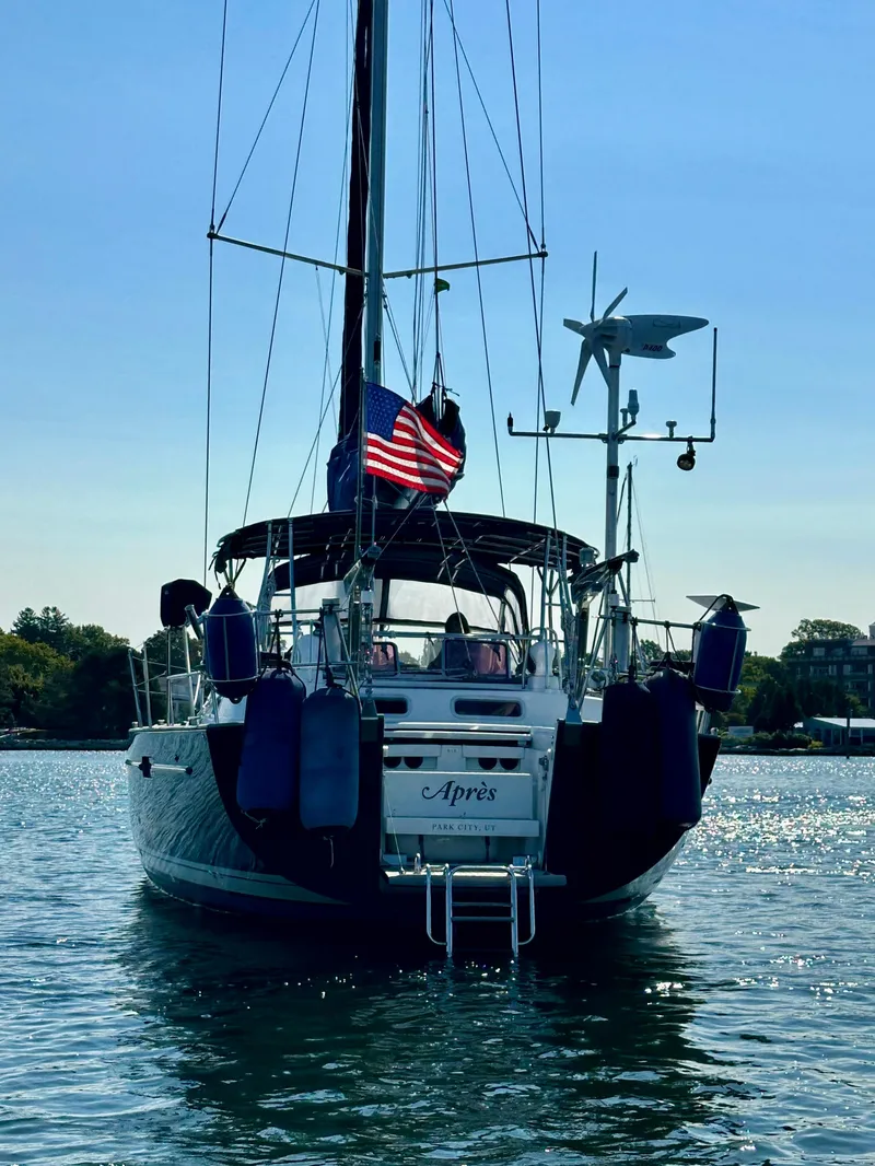 Slide: The Image of Sailing yacht Beneteau 57, 2010 model, with American flag, anchored in calm waters. - 2