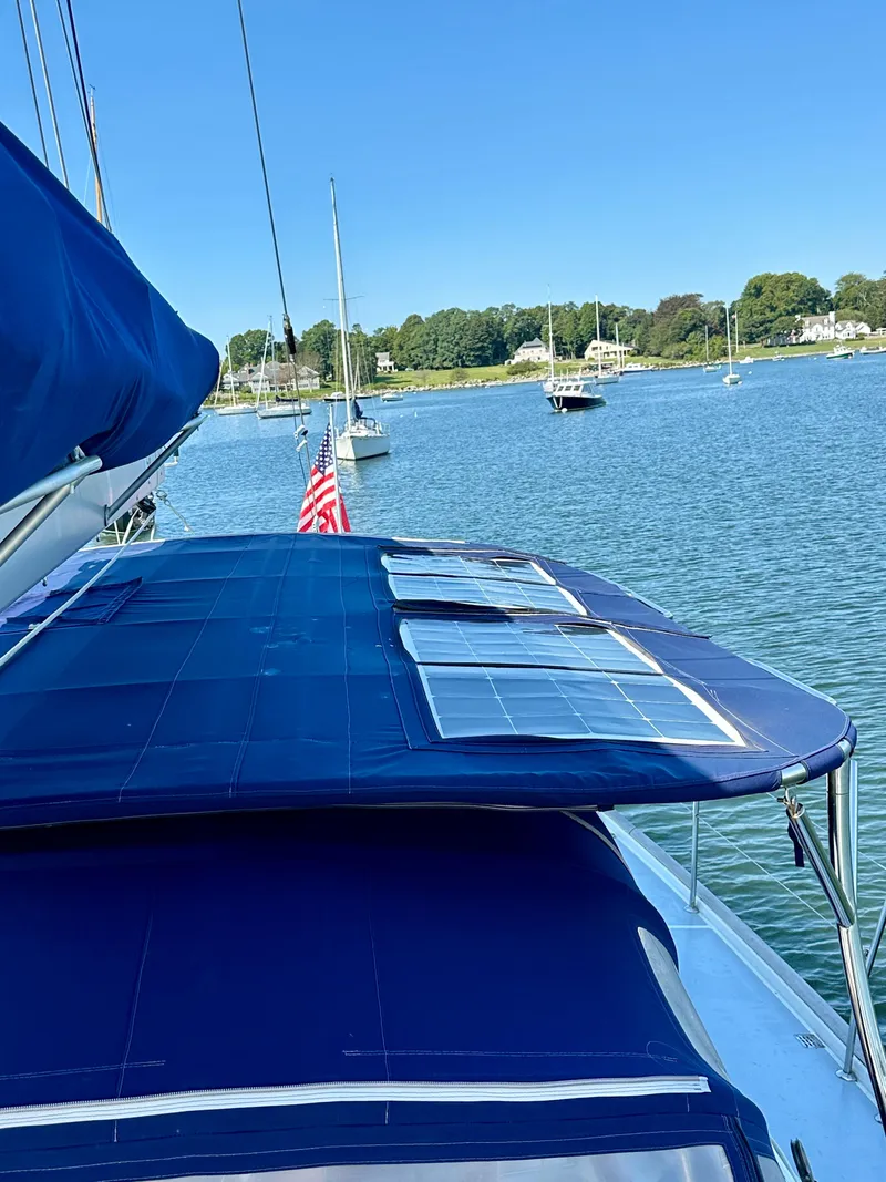 Slide: The Image of Sailboat Beneteau 57 (2010) with solar panels, docked in a serene harbor. - 20
