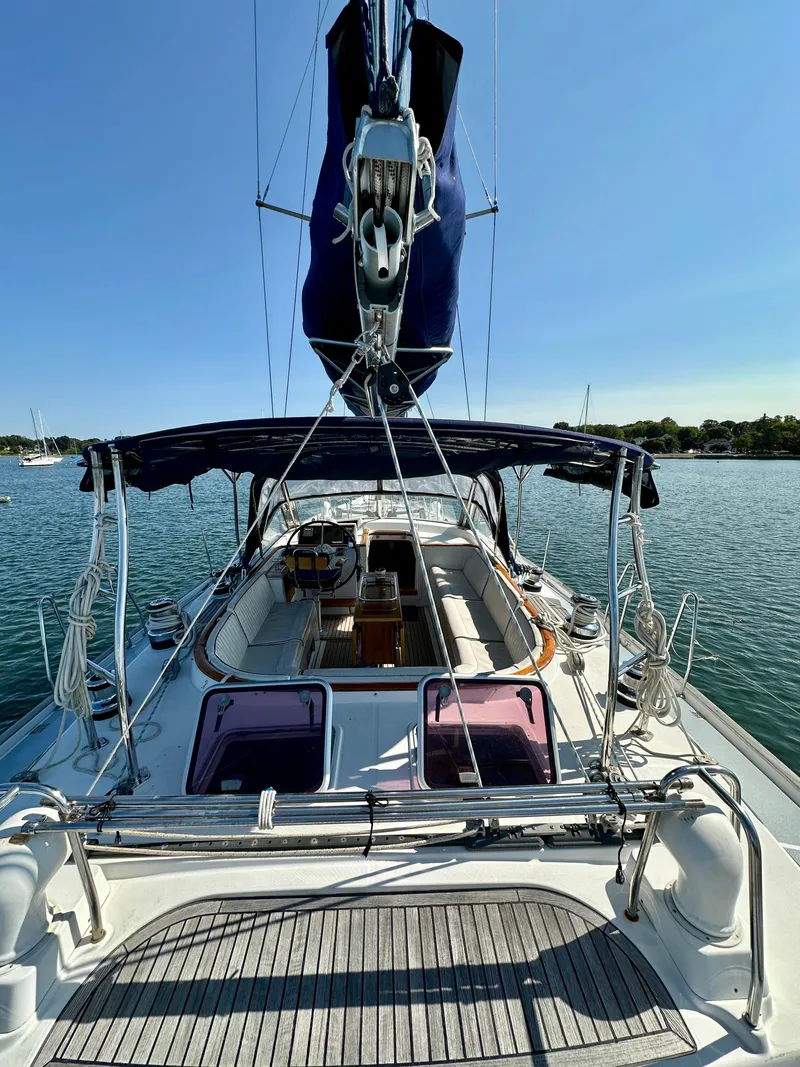 Slide: The Image of Beneteau 57 sailboat, 2010 model, docked on calm water under clear blue sky. - 26