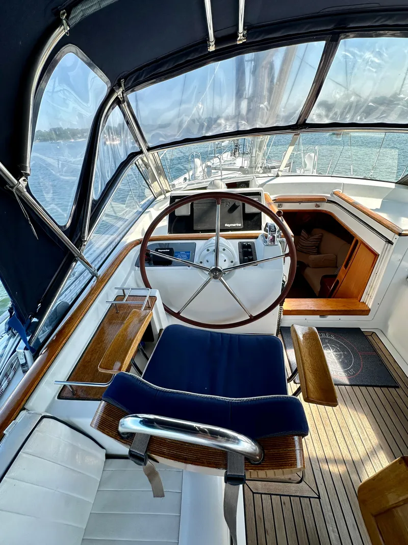 Slide: The Image of Cockpit of 2010 Beneteau 57 sailboat with wooden accents and steering wheel. - 28
