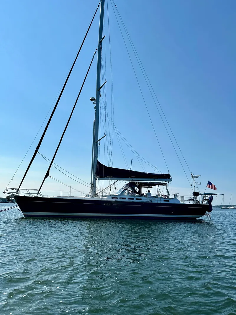 Slide: The Image of 2010 Beneteau 57 sailboat on calm water under clear blue sky. - 3