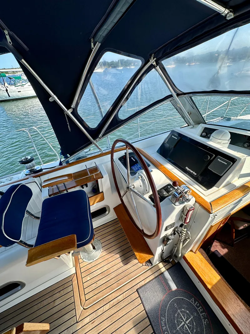 Slide: The Image of Cockpit of 2010 Beneteau 57 yacht with wooden steering wheel and navigation equipment. - 30