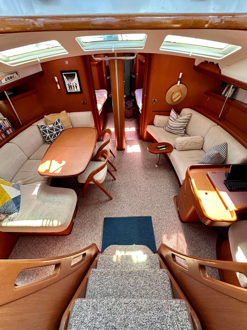 Slide: The Image of Interior of 2010 Beneteau 57 yacht with elegant seating and dining area. - 32